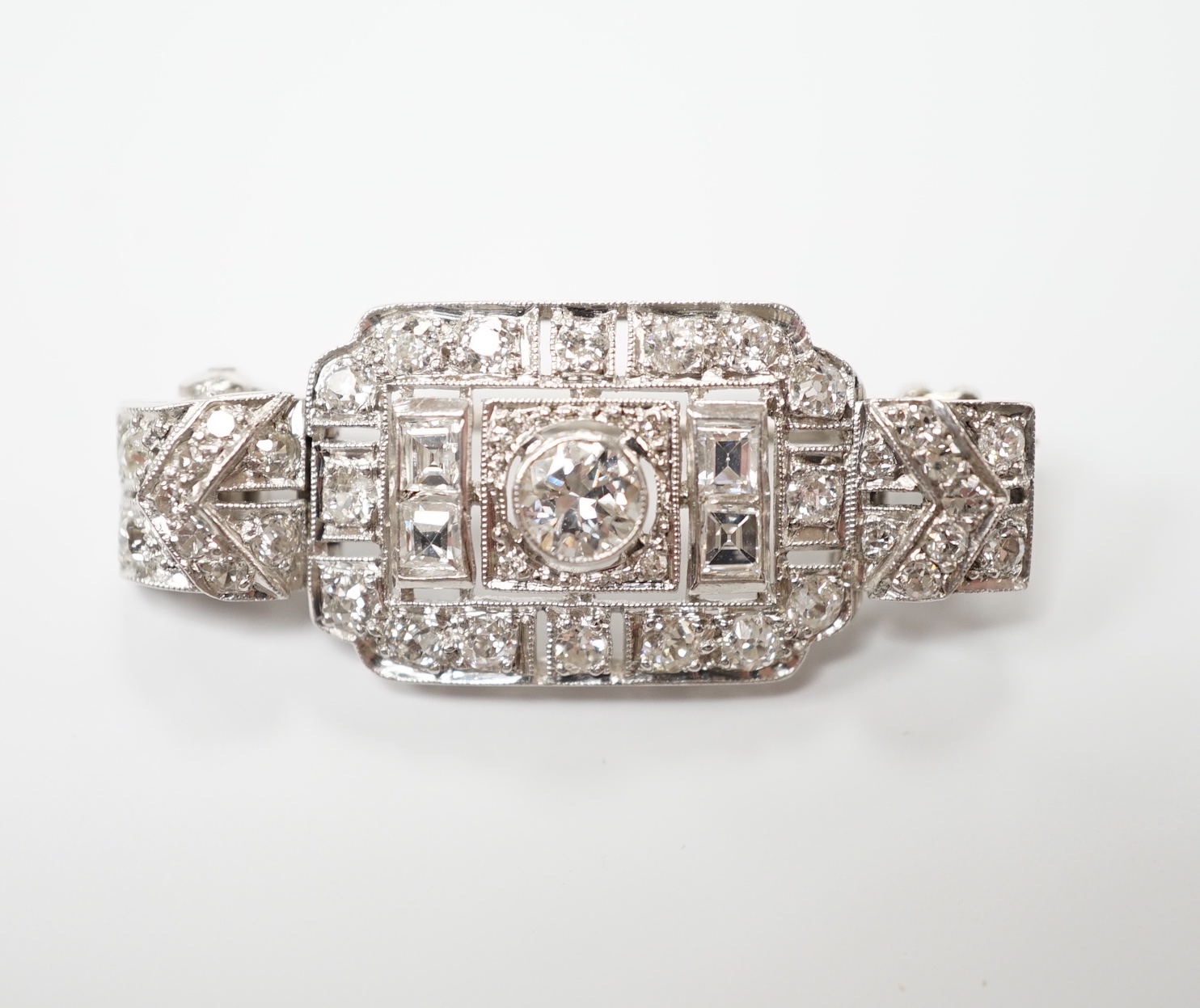 An Art Deco style white metal and diamond cluster set pendant brooch, overall 38mm, gross weight 5.9 grams.